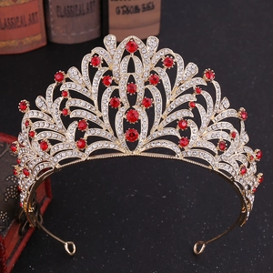 Close-up of golden leaf crown with inlaid rhinestones and large red rubies