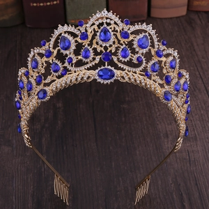 Macro view of bridal crown with blue gemstones and white rhinestones on golden combs