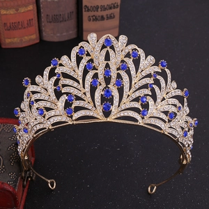 Macro detail of royal baroque tiara with blue gemstones and sparkling white rhinestones
