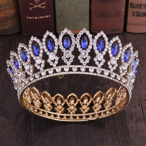 Close-up of golden Baroque bridal crown with blue marquise crystals and clear rhinestones