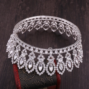 Macro detail of silver baroque bridal crown with zircon crystals on dark wood base