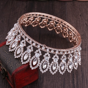 Close-up of Baroque rose gold bridal crown with crystal droplets on a vintage red box