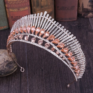 Detail of peacock tail crown with golden alloy and champagne teardrop crystals