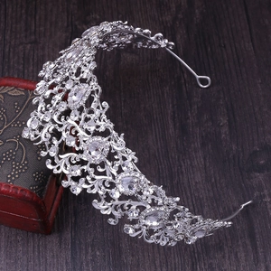 Detailed view of silver bridal crown with intricate leaf patterns and sparkling rhinestones