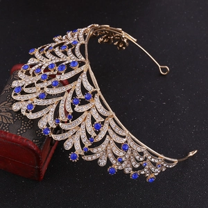 Detail view of gold leaf bridal crown with sparkling rhinestones and blue pear gemstones