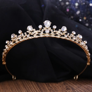 Elegant gold bridal tiara with sparkling rhinestones and leaf pattern on dark satin