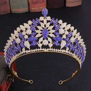 Close-up of luxury bridal crown with blue rhinestones and gold leaf patterns