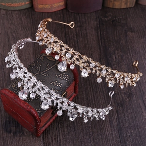 Elegant gold and silver bridal tiaras with rhinestone leaf patterns on vintage box