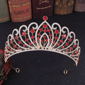 Detailed macro view of luxury baroque golden crown with red rhinestones and alloy patterns