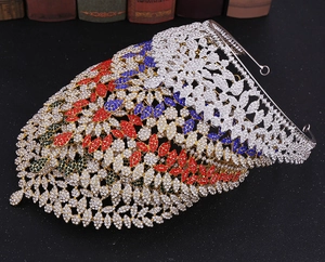 Detailed close-up of a vintage golden crown with multi-color rhinestones and butterfly design