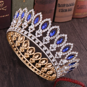 Detail shot of vintage golden baroque crown featuring marquise blue gems and rhinestones