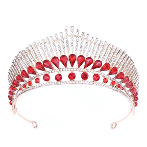 Close-up of alloy crown with peacock tail design, red teardrop gems, and white rhinestones