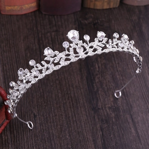Macro detail of silver bridal crown showing intricate rhinestone leaves and crystals