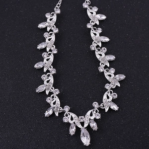 Elegant bridal necklace set with crystal leaf patterns on a premium black background