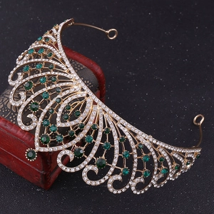 Close-up of green and white crystals on golden baroque crown over red vintage box