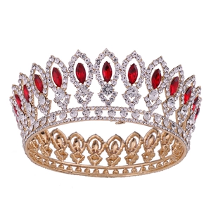 Detailed close-up of golden Baroque bridal crown with red marquise stones and white rhinestones