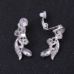 Detailed macro view of silver alloy bridal earrings with marquise crystal leaf design