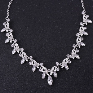 Close-up detail of silver-toned bridal necklace with crystal leaf and floral patterns