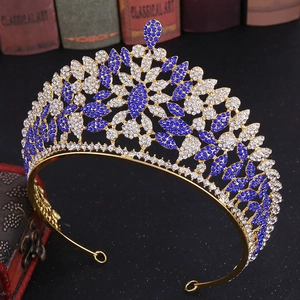 Detailed view of luxury rhinestone crown with deep blue crystals and golden frame