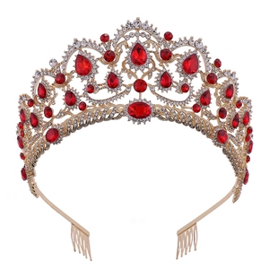 Close-up of golden bridal crown with red gemstones and intricate hollow floral details