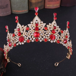 Detail of vintage baroque bridal crown with red rhinestones on a golden alloy base