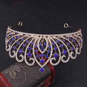 Detail view of Baroque crown with blue rhinestones on a vintage wooden box