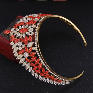 Macro detail of luxury gold bridal crown with red and white crystal leaves