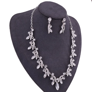 Elegant bridal crystal necklace and earring set with leaf-shaped stones on display
