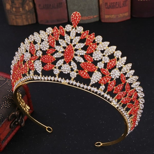 Detail of luxury gold tiara with red and white rhinestones on vintage book background