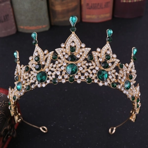 Detail showing baroque vintage gold crown with emerald green crystals and zircon accents