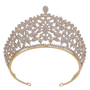 Close-up of gold pageant crown featuring intricate leaf patterns and clear crystal details