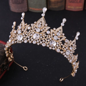 Close-up detail of Baroque vintage bridal crown with clear crystals and gold alloy finish