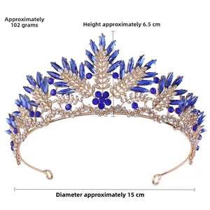Detail view of a vintage blue crystal crown with gold alloy scrollwork and floral motifs