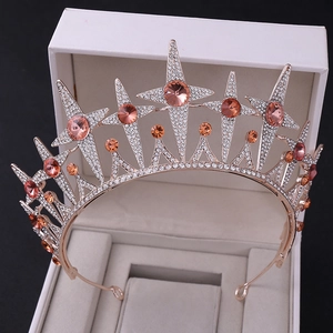 Elegant rose gold star crown with peach pink stones and crystals on jewelry box