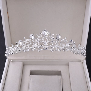 Macro view of bridal crown with silver floral patterns and pear-cut crystal rhinestones