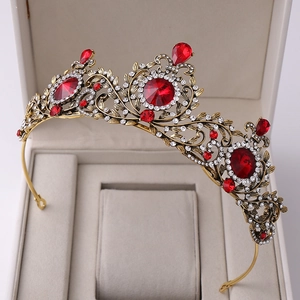Close-up of Baroque vintage leaf crown with red crystals on beige velvet jewelry box