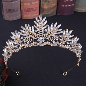 Close-up of golden leaf bridal crown with sparkling crystal rhinestones and vintage art book