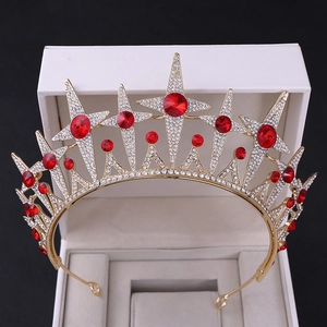 Macro shot of gold bridal crown featuring red star gems and shimmering crystal pavé
