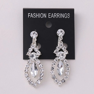 Detailed view of silver alloy tassel earrings with sparkling clear crystals and marquise stones