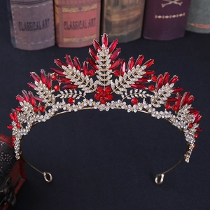 Detail of red crystals and gold alloy leaves on a vintage style bridal crown tiara