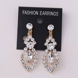 Detail of luxury gold rhinestone earrings with marquise cut drop and shiny crystal inlay