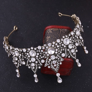 Close-up of Baroque bronze bridal crown with sparkling crystals and floral leaf patterns