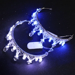 Elegant bridal crown with blue LED lights and clear crystal beads on silver metal frame
