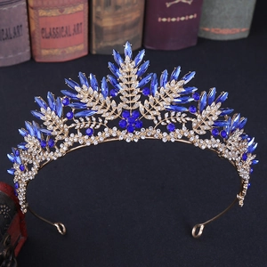 Close-up of golden baroque tiara with navy blue marquise crystals and white rhinestones