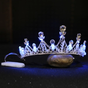 Close-up of alloy crown with teardrop crystals and glowing blue LED light effect