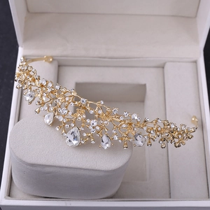 Detailed macro view of golden flower tiara with sparkling rhinestones and pear-cut crystals