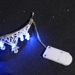 Detailed macro view of the alloy crown featuring LED lighting and crystal beads