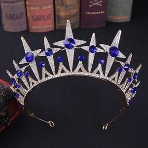 Detail of a vintage golden bridal crown with blue rhinestones on classical books