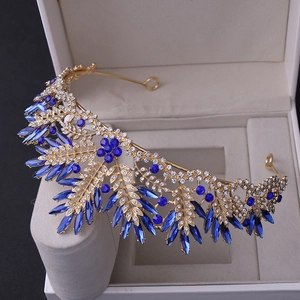 Detailed macro of golden floral bridal crown with royal blue marquise rhinestones