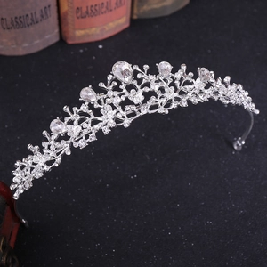Close-up of silver bridal tiara with sparkling rhinestones on a vintage book